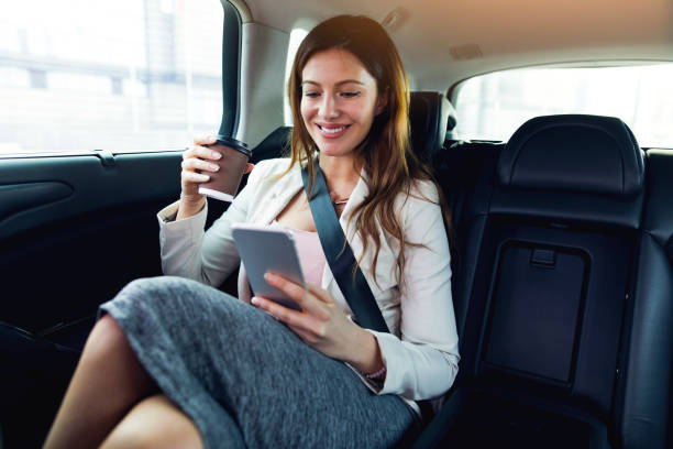 istock Successful businesswoman in a car using mobile phone. 678830120