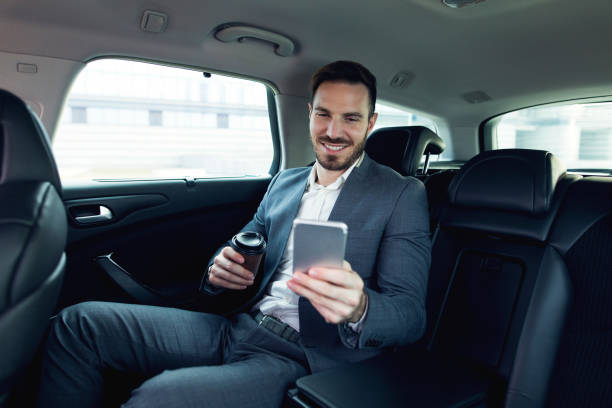 istock Successful businessman in a car and text messaging. 678830582