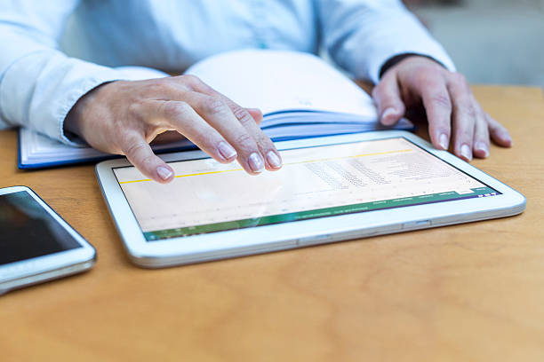 istock Close-Up Of Hand Tapping Tablet 678834839