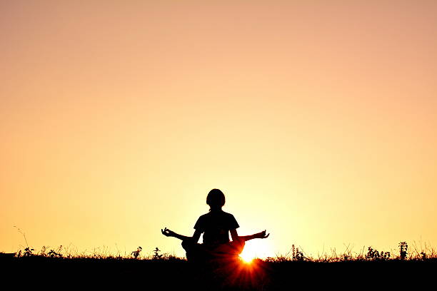 istock Person In Lotus Position At Sunset 678835191