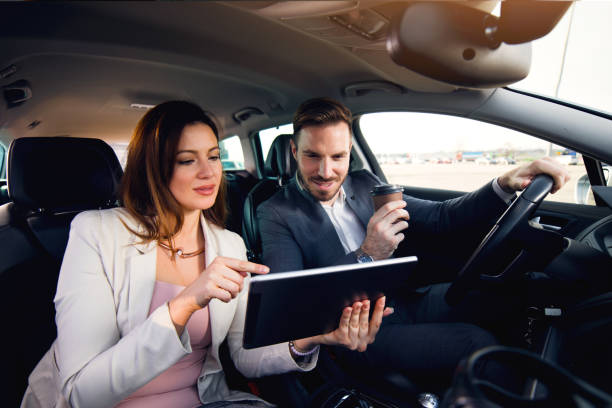 istock Business couple using digital tablet in the car 678837398