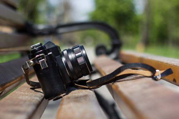 istock Photo camera on a bench in a park 678838854