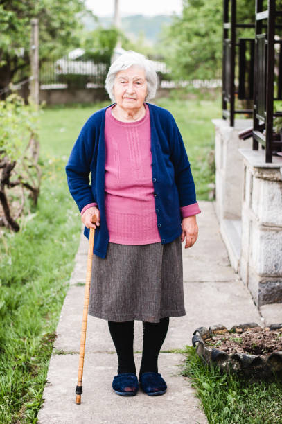 istock Grandmother walks with a cane in his hand 678842734
