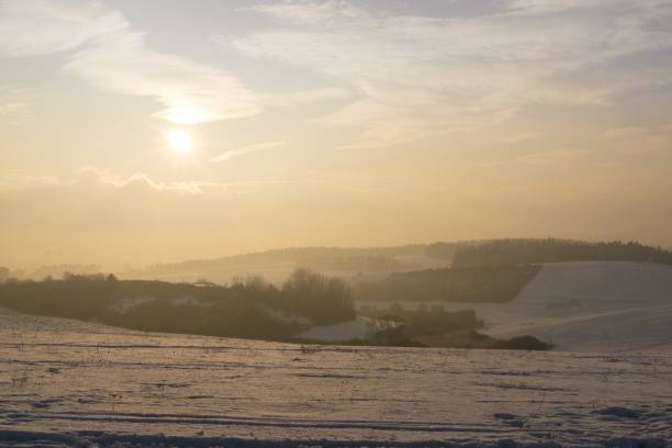 istock Sunrise on meadow covered by snow during winter. 678847754