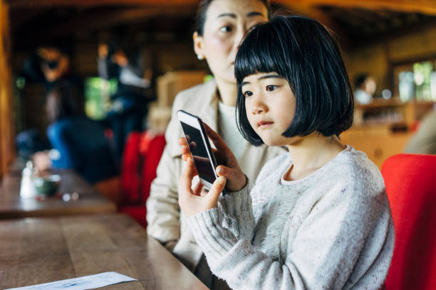 istock Japanese family using smartphone together 678853068