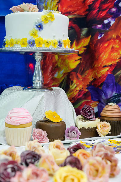 istock Delicious cake and cupcakes with edible flowers 678860952