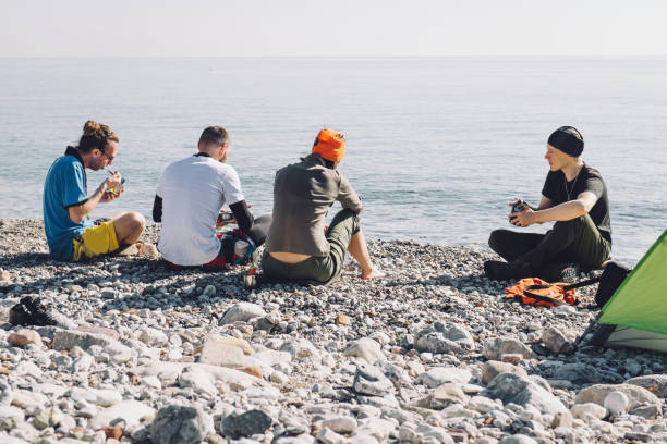 istock Happy friends camping on the beach 678872400