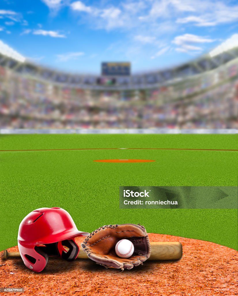 Baseball Stadium With Equipment and Copy Space Baseball stadium full of fans in the stands with baseball helmet, bat, glove and ball on infield dirt clay. Deliberate focus on foreground with shallow depth of field on background. Copy space. Baseball - Ball Stock Photo