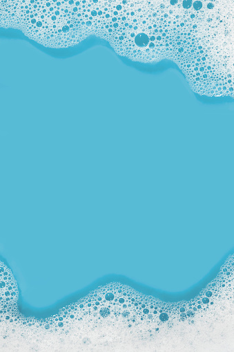 Frame made of soap sud with water in blue tones. High resolution - 50 megapixels. Space for copy.