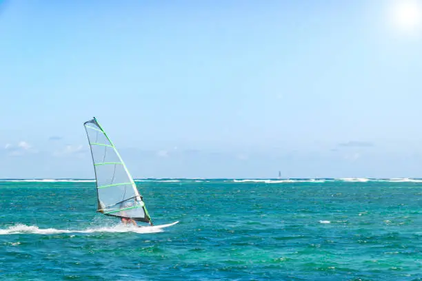 Windsurfing. Windsurfer Surfing The Wind On Waves In Ocean, Sea. Extreme Sport Action. Recreational Sporting Activity. Healthy Active Lifestyle