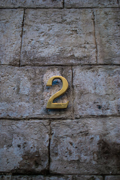 istock Number two. Grey bricked wall of an old house. 678908720