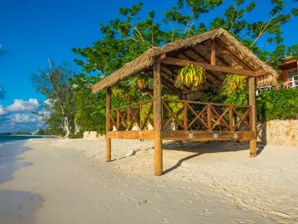 Wooden hut with suspended flower pots facing the Caribbean Sea, Grand Cayman