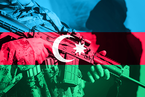 Soldier with machine gun with national flag of Azerbaijan