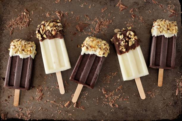 istock Chocolate and almond dipped white and dark popsicles on rustic metal 678933550