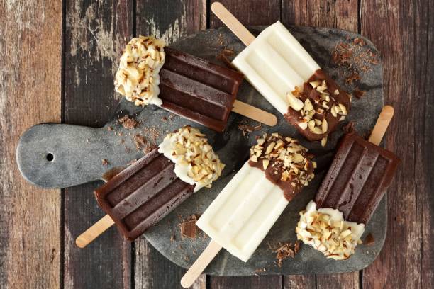 istock Chocolate and almond dipped popsicles on a dark background 678933710