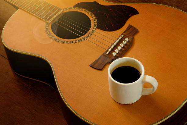 istock cup of coffee put on acoustic guitar 678936516