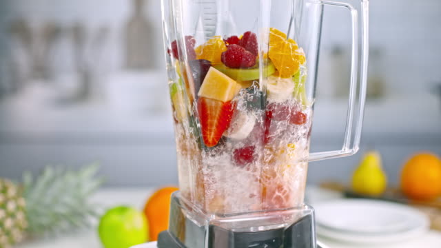 SLO MO Mixed fruit smoothie being blended in the jar