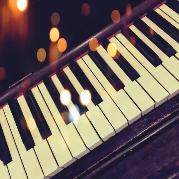 Retro piano keys with bokeh lights effect.
