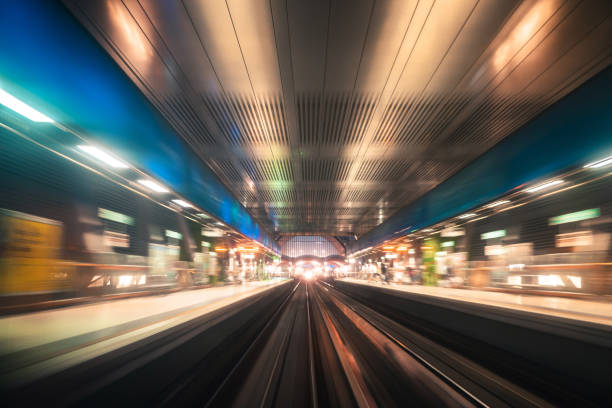 fast train running in the city of london - canary wharf railway station imagens e fotografias de stock