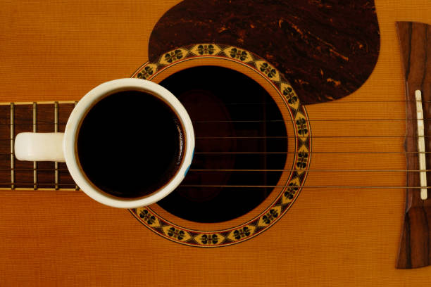 istock cup of coffee put on acoustic guitar 678952204