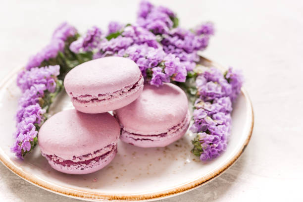 istock spring woman breakfast with macaroons and mauve flowers white background 678955840