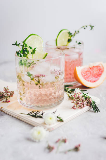 istock pink fresh cocktail with grape-fruit and cut lime on stone desk background 678966396