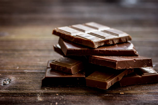 istock black and milk chocolate bars dark wooden table background 678970170