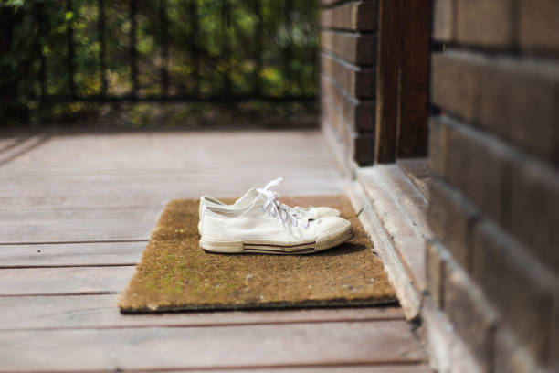 istock Home Moments- One pair of withe sneaker shoes on a porch 678970336