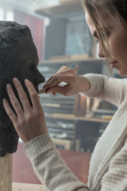istock Young sculptor creates a clay sculpture 678970426