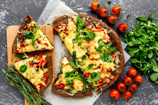 istock cooking pizza with vegetables and cheese on stone desk background top view 678970896