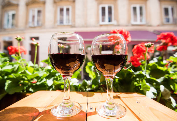 two glasses of red wine on the vibrant restaurant background. selective focus. - bentham imagens e fotografias de stock