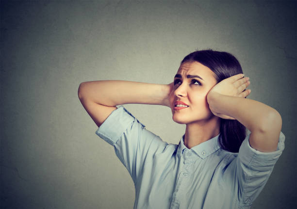 Stressed frustrated woman covering her ears with hands. Stressed frustrated woman covering her ears with hands. inconvenience photos stock pictures, royalty-free photos & images