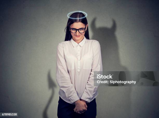 Shy Quiet Angel Woman With Devil Character Stock Photo - Download Image Now - Devil, Women, Mischief