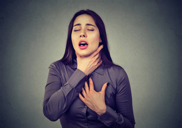 woman having asthma attack or choking can't breath suffering from respiration problems - gasping imagens e fotografias de stock