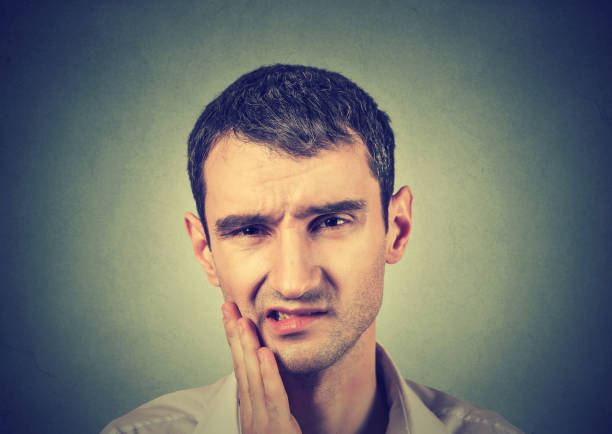 istock young man with a toothache tooth pain 678987406