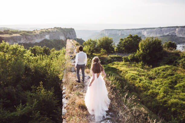 istock Wedding couple walking in the mountains with stunning views 679009150