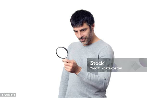 Darkhaired Man Looking With Magnifying Glass Stock Photo - Download Image Now - Analyzing, Business, Business Finance and Industry