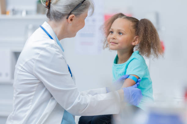 istock Doctor puts bandage on young patient's arm after receiving immunization 679028390
