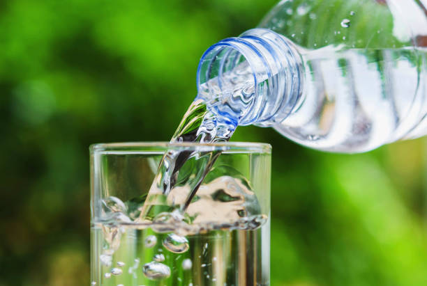 istock Drinking water poured into the glass and sunlight background 679069360