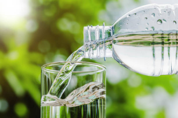 istock Drinking water poured into the glass and sunlight background 679069432