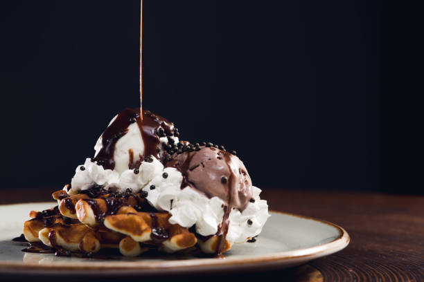 eis mit schokoladensauce und waffel - waffle syrup pouring breakfast stock-fotos und bilder