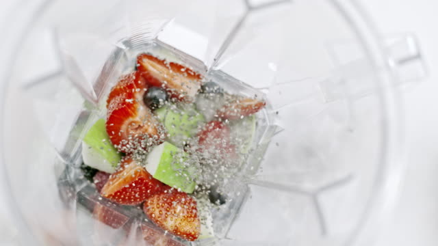 SLO MO Adding chia seeds into blender jar with fruits