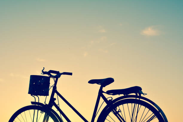 istock Silhouette of old bicycle on grass with the sky sunset 679111774