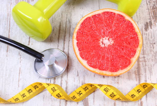istock Fresh grapefruit, centimeter, stethoscope and dumbbells, healthy lifestyles 679118874