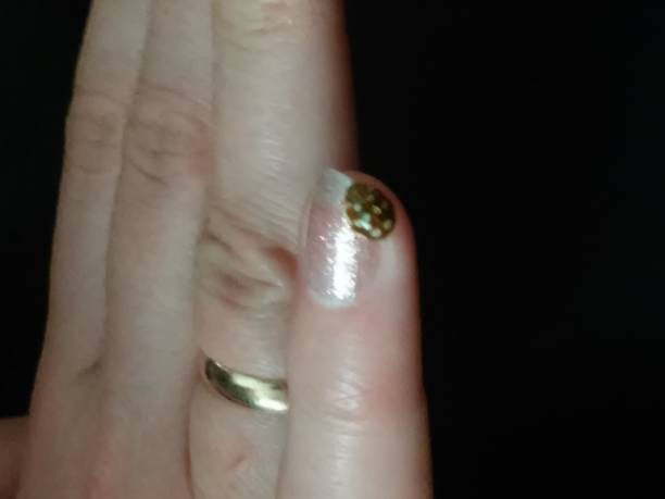 istock Ladybug on nail and finger with wedding ring. 679186840