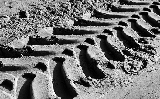 Tyre tracks on sand in black and white. abstract background for design ad ideas