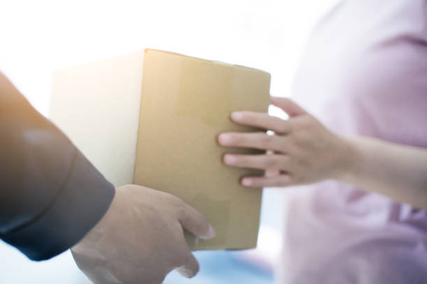 istock Woman hand accepting a delivery of boxes 679220366