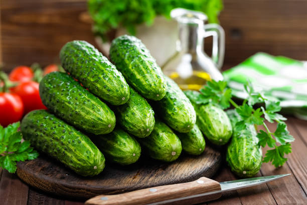 istock Fresh cucumbers on wooden table 679222938