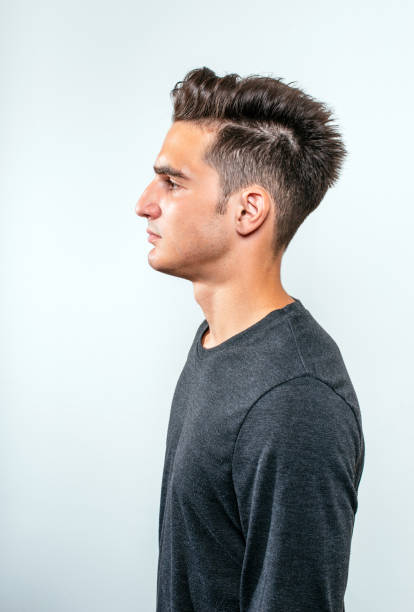 Handsome young man Portrait of handsome young man with modern undercut hairstyle, dressed in casual dark clothing and posing half shaved hairstyle stock pictures, royalty-free photos & images
