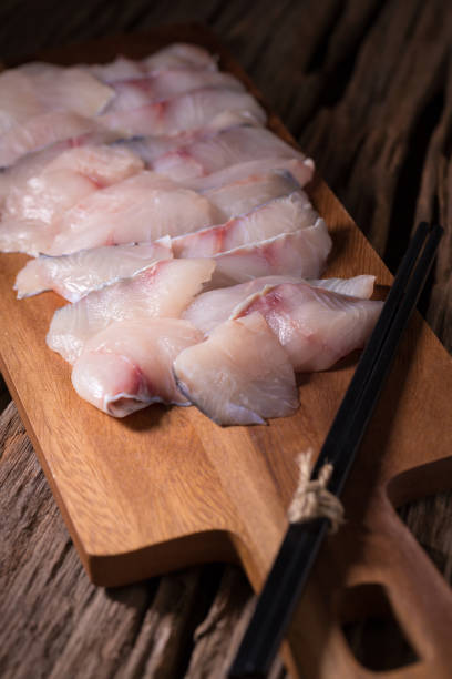 istock Raw white fish fillets on a wooden board background 679225132